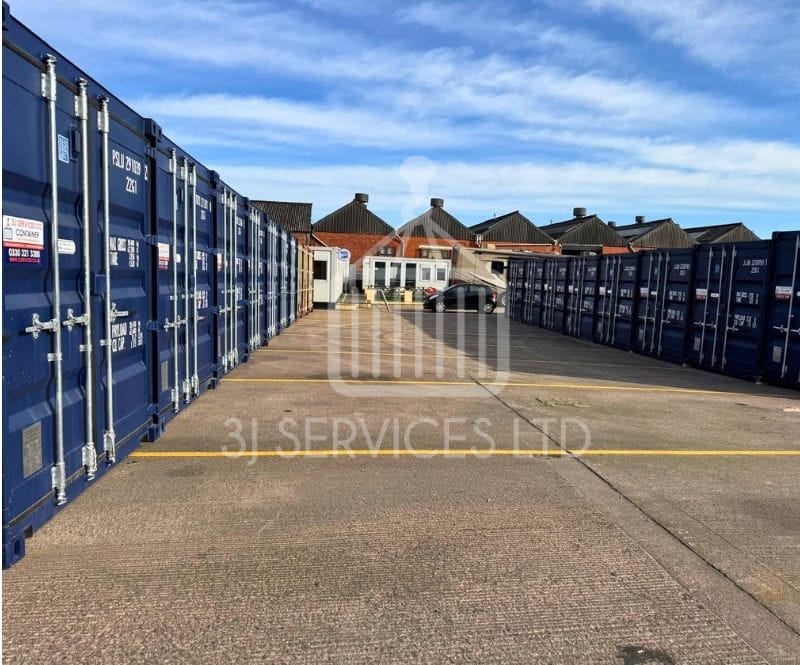 blue shipping containers on a concrete industrial site