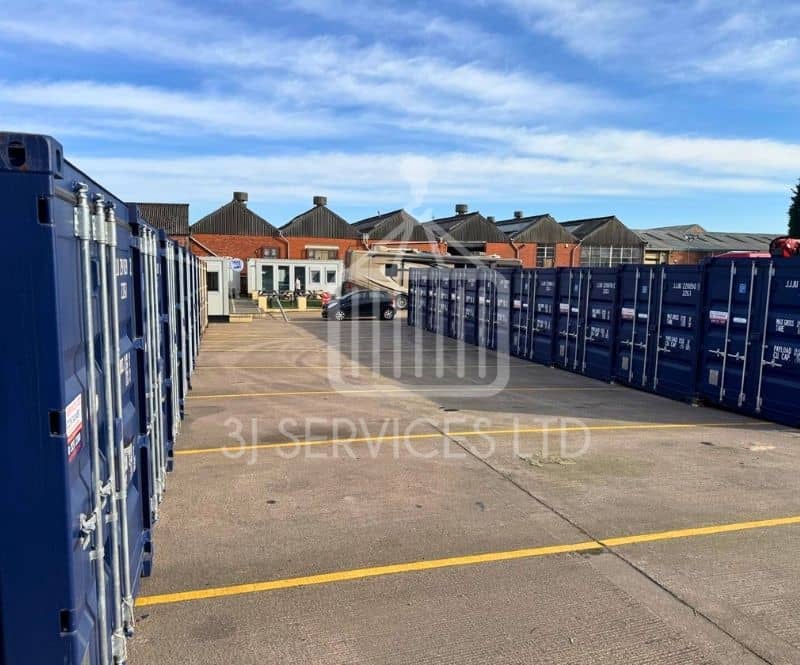 blue shipping containers on a concrete industrial site