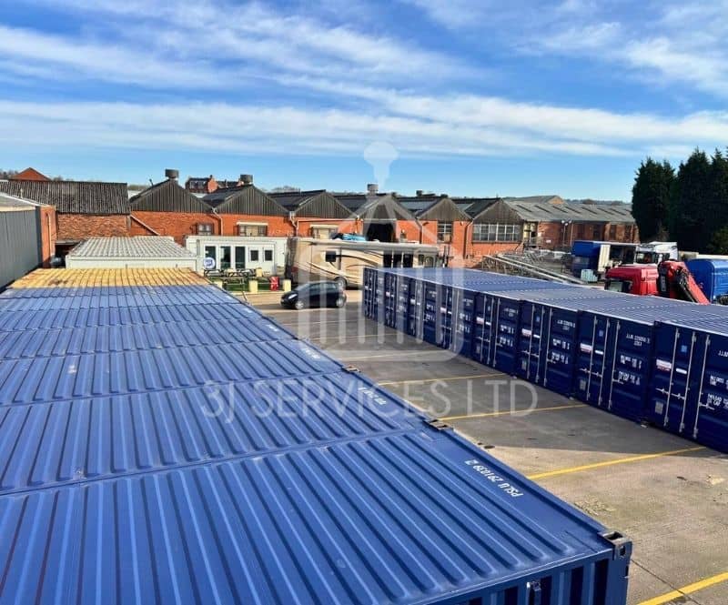 blue shipping containers on a concrete industrial site