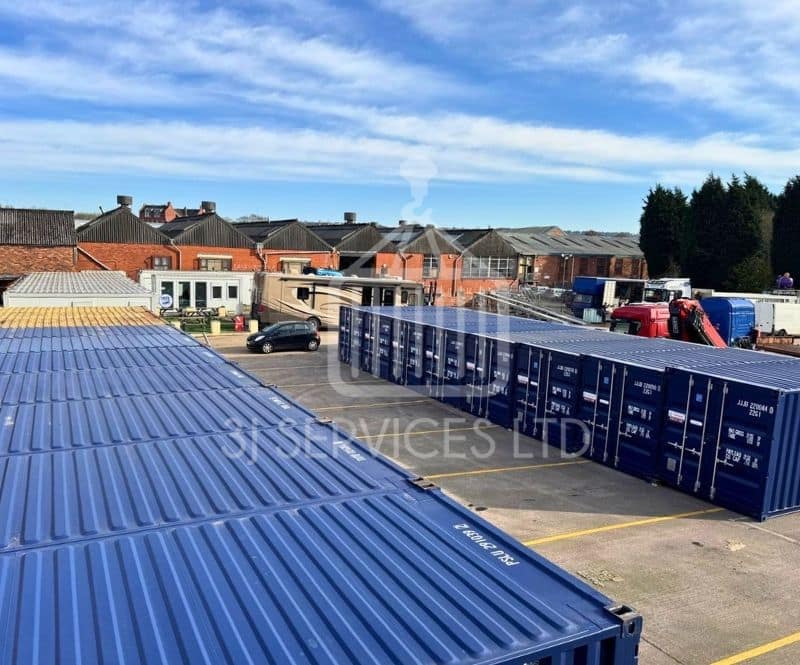 blue shipping containers on a concrete industrial site