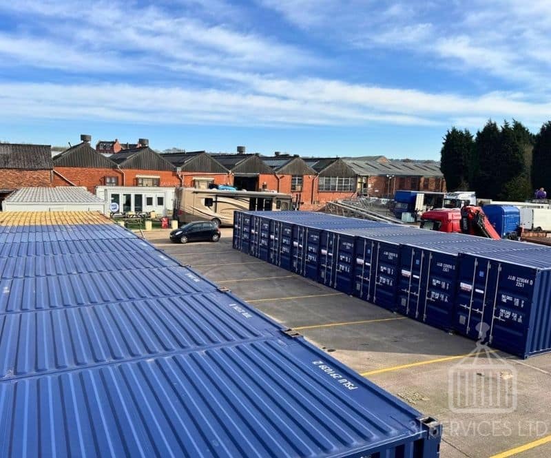 blue shipping containers on a concrete industrial site