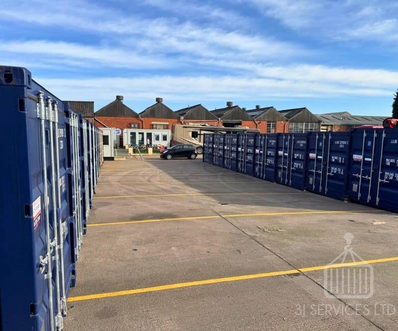 blue shipping containers on a concrete industrial site
