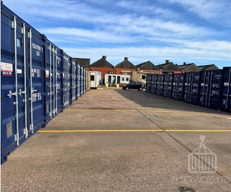 blue shipping containers on a concrete industrial site