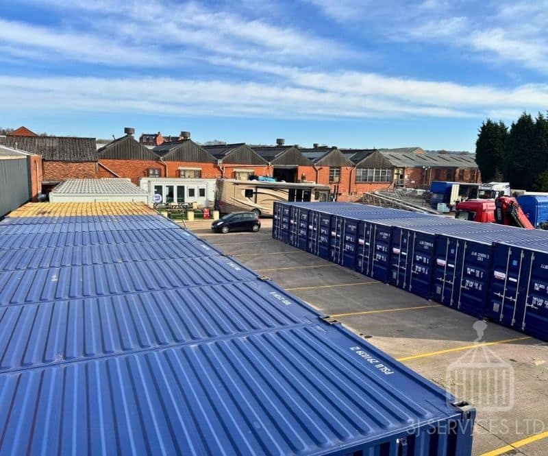 blue shipping containers on a concrete industrial site